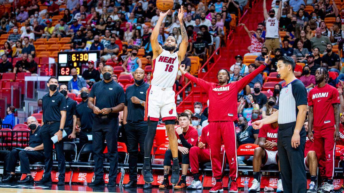 Miami Heat forward Caleb Martin (16) attempts a three-point shot during the first half of an NBA preseason game against the Charlotte Hornets at FTX Arena in Downtown Miami, Florida, on Monday, October 11, 2021. The Heat won 104-103.