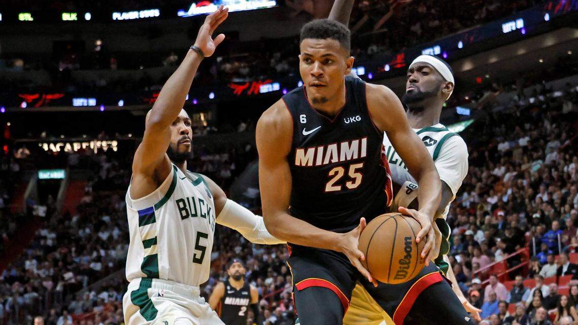 Miami Heat center Orlando Robinson (25) on a rebound under the basket as Milwaukee Bucks guard Jevon Carter (5) and forward Bobby Portis (9) defend in the fourth quarter in Miami on Thursday, January 12, 2023.