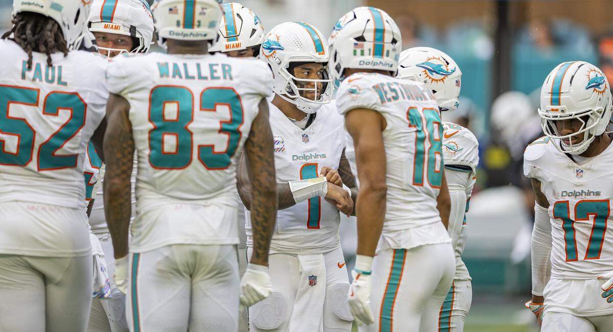 Miami Dolphins quarterback Tua Tagovailoa (1) huddles with his teammates in the second half of their NFL game against the Los Angeles Chargers at Hard Rock Stadium on Sunday, Oct. 12, 2025, in Miami Gardens, Fla.