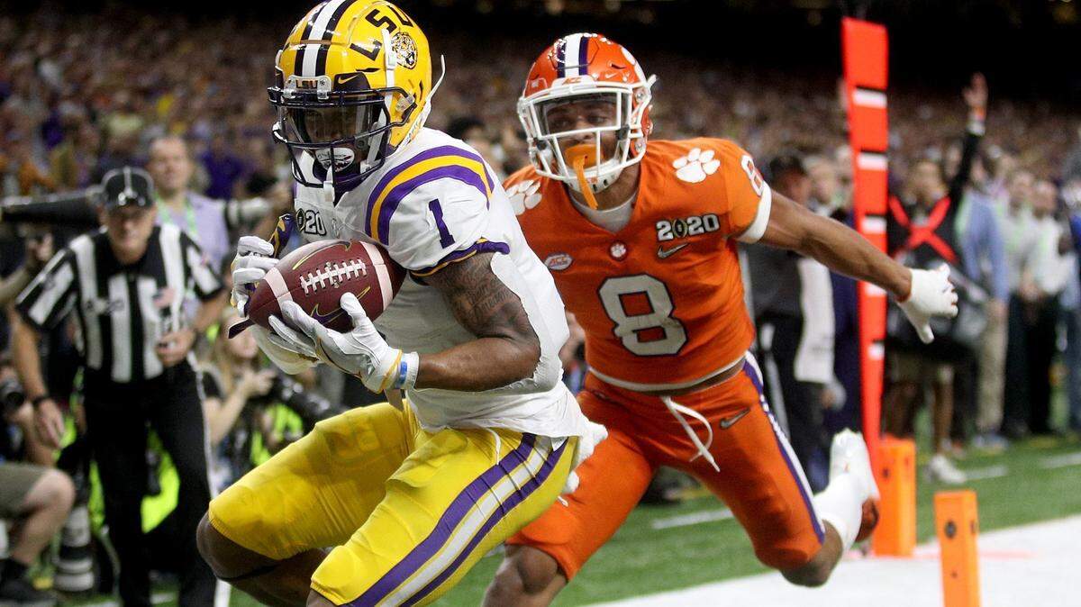 NEW ORLEANS, LOUISIANA - JANUARY 13: Ja’Marr Chase #1 of the LSU Tigers scores a touchdown as A.J. Terrell #8 of the Clemson Tigers defends in the College Football Playoff National Championship game at Mercedes Benz Superdome on January 13, 2020 in New Orleans, Louisiana. (Photo by Chris Graythen/Getty Images)