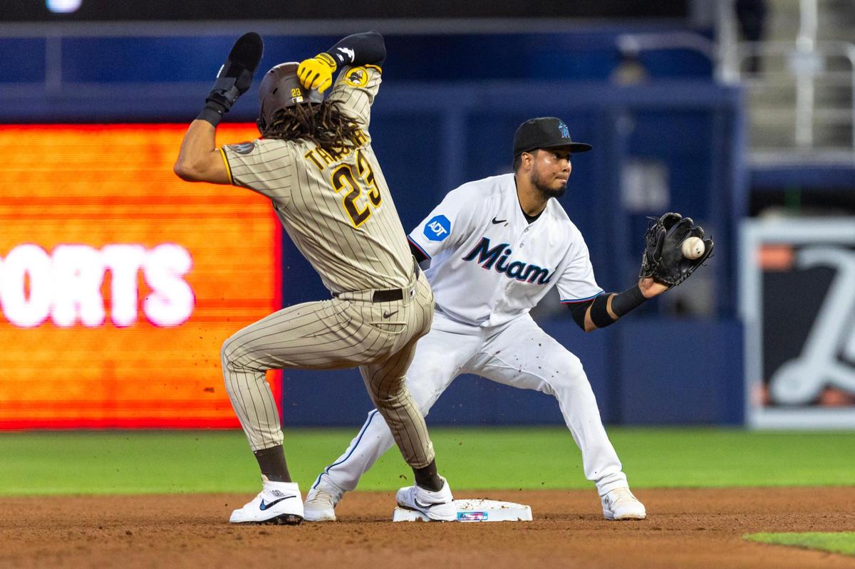 Miami Marlins second baseman Luis Arraez (3) catches the ball from catcher Nick Fortes (4) as he attempts to tag out San Diego Padres base runner Fernando Tatis Jr. (23) during the fourth inning of an MLB game at loanDepot park in the Little Havana neighborhood of Miami, Florida, on Thursday, June 1, 2023.