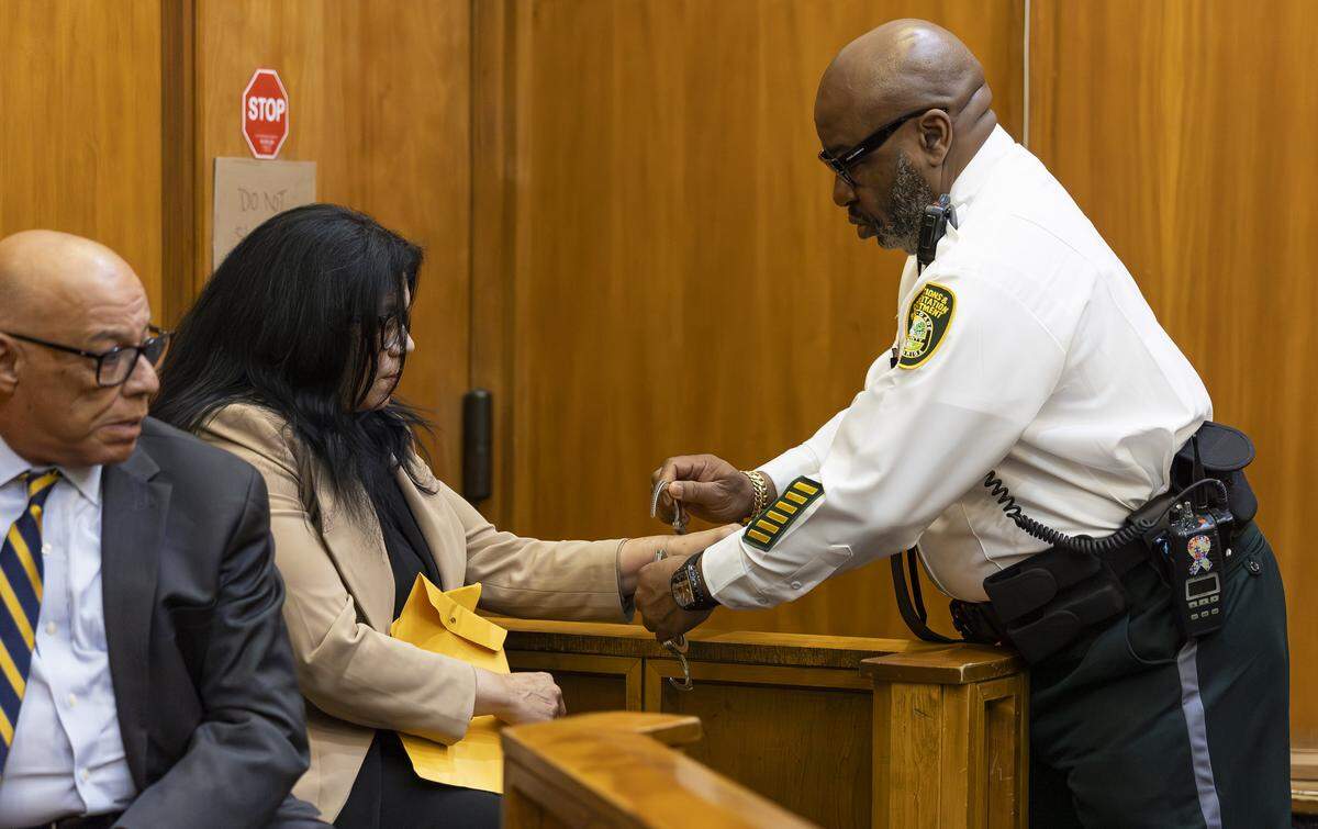 Former Miami-Dade School Board member Lubby Navarro is taken into custody after her plea hearing at the Richard E. Gerstein Justice Building on Tuesday, April 14, 2026, in Miami, Fla. Navarro plead guilty to spending up to $100,000 of district funds while in office.