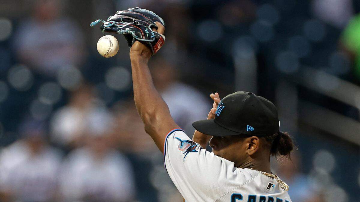 Miami Marlins pitcher Edward Cabrera knocks down the ball hit by New York Mets’ Brandon Nimmo during the first inning of the second game of a baseball doubleheader, Tuesday, Aug. 31, 2021, in New York. Nimmo was safe with a single. (AP Photo/Adam Hunger)