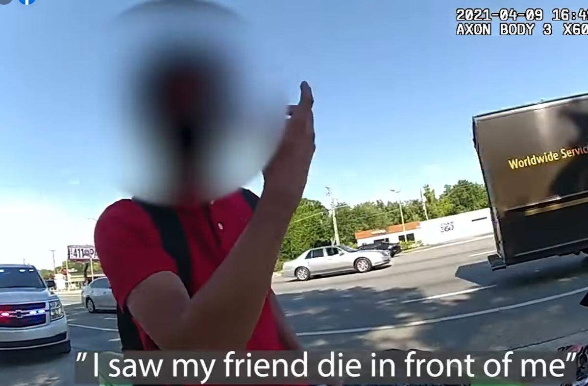 Screen grab from body cam footage of Hillsborough County Sheriff Deputy Donald Rizer consoling a motorcyclist he pulled over on April 18, 2021.