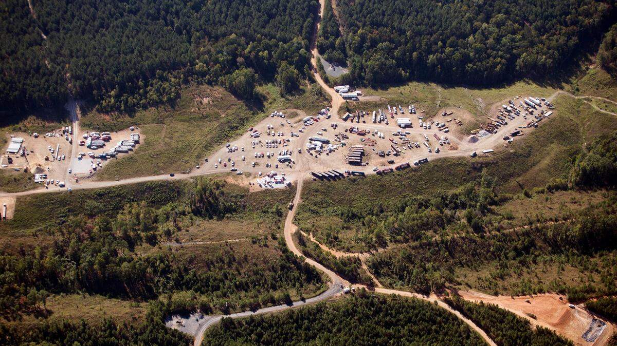 FILE - In this Sept. 20, 2016 file photo, vehicles are seen near Colonial Pipeline in Helena, Ala. The company, which transports fuels along the East Coast, said it had to pause operations because it was the victim of a cyberattack. (AP Photo/Brynn Anderson, File)