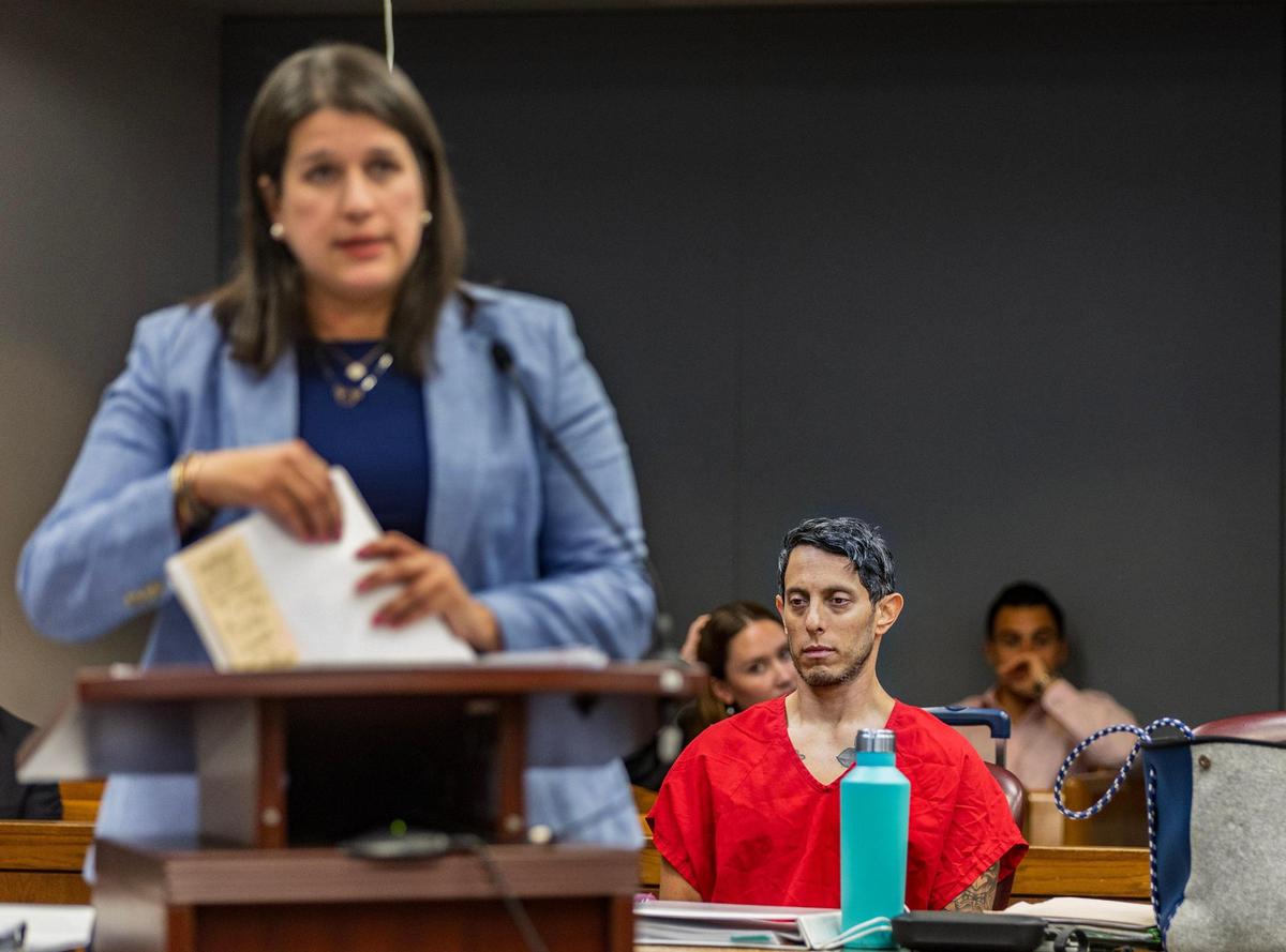 La abogada defensora Beatriz Llorente, con su cliente Oscar Olea sentado detrás de ella, interroga a un detective de Key Biscayne.