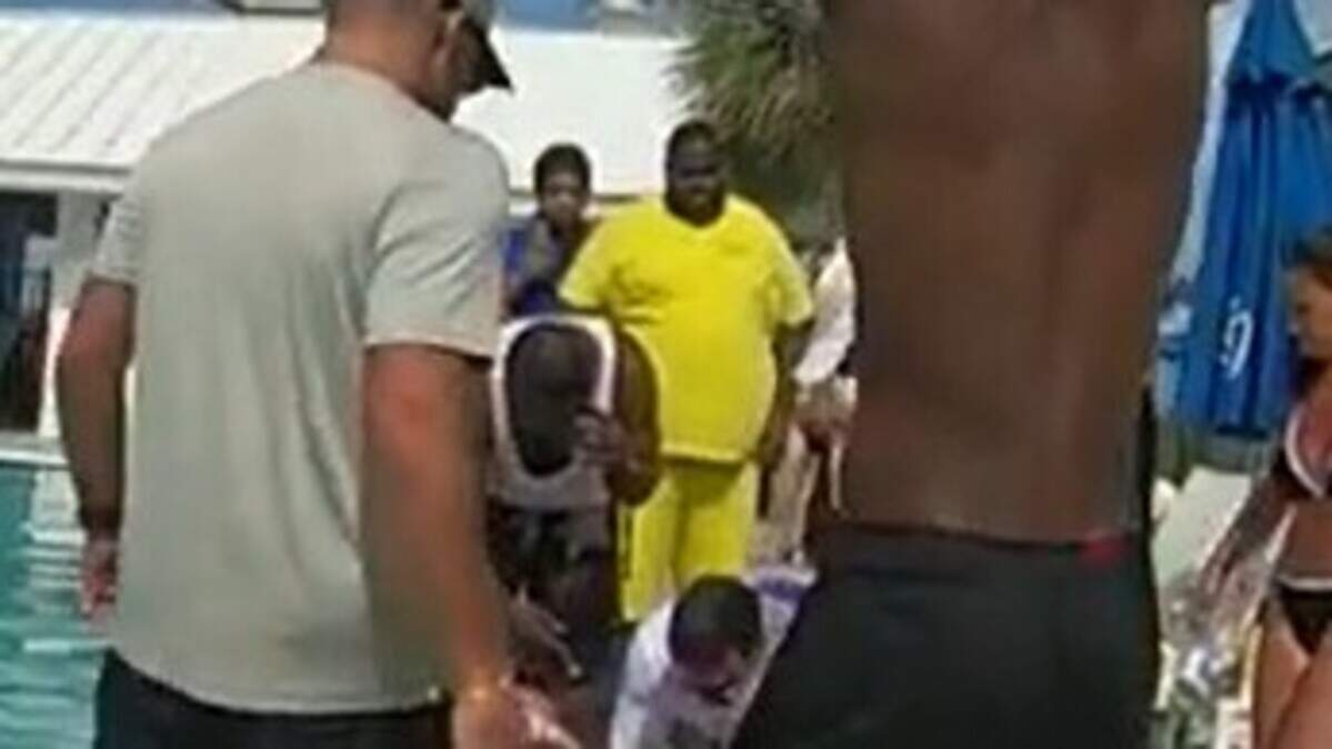 Bystanders watch as off-duty paramedics and nurses perform CPR on a small child who was found unresponsive at a Lauderdale-By-The Sea resort pool May 24, 2026.