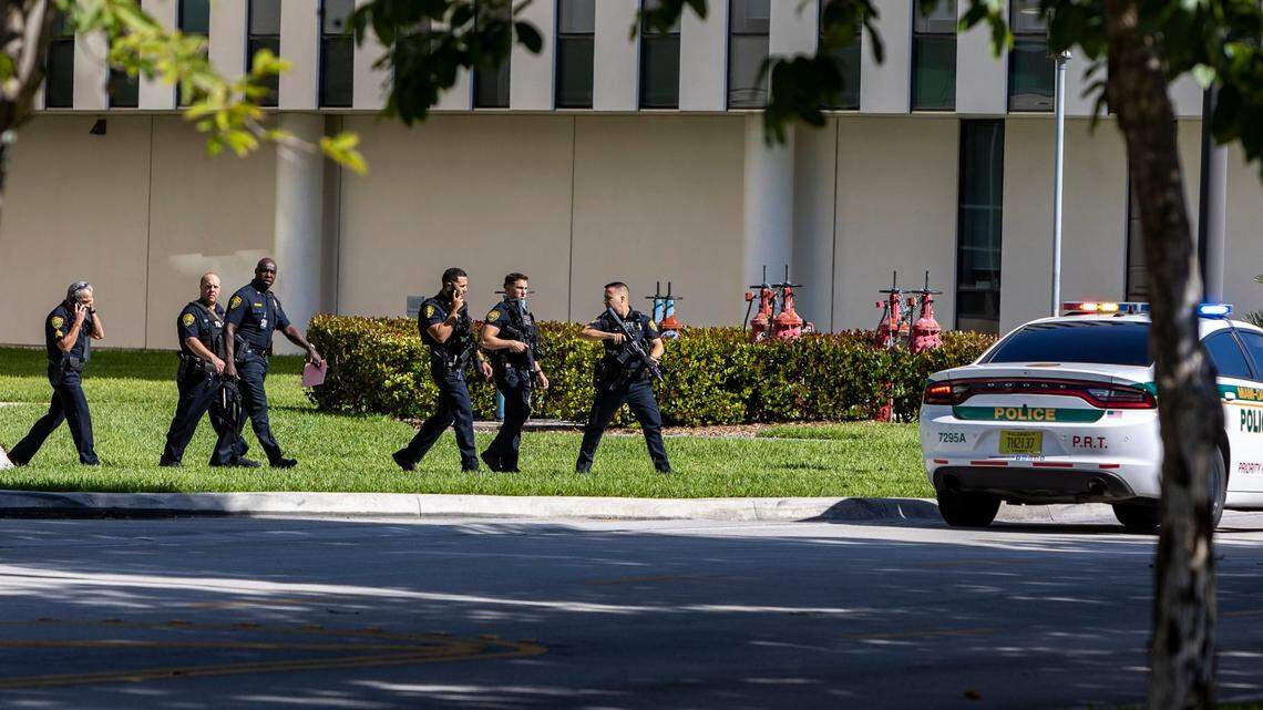 Miami, Florida - May 2, 2023 - Police walk to their vehicles inside the FIU main campus prior to the all clear.