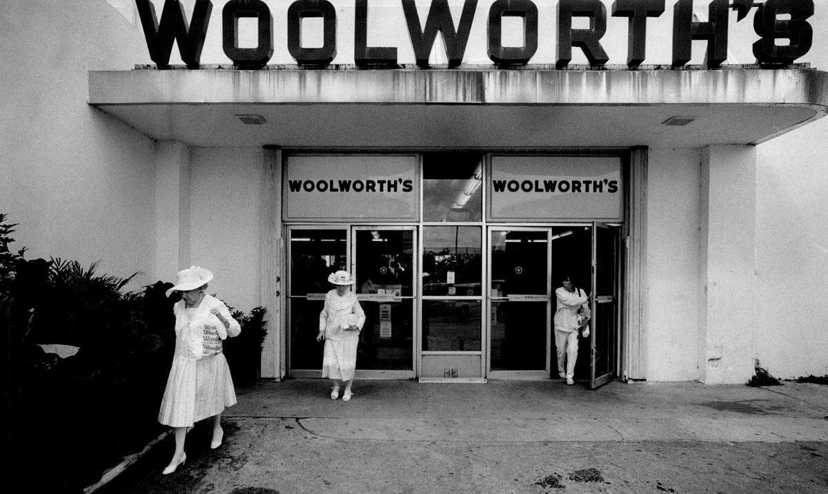 Shoppers leave through the back entrance of a Miami Woolworth store in 1994.