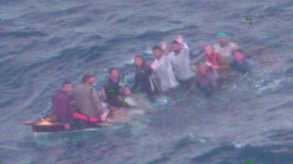 A group of 10 people from Cuba float on a sinking vessel off Key Largo Thursday, Feb. 3, 2022, before being rescued by the U.S. Coast Guard.