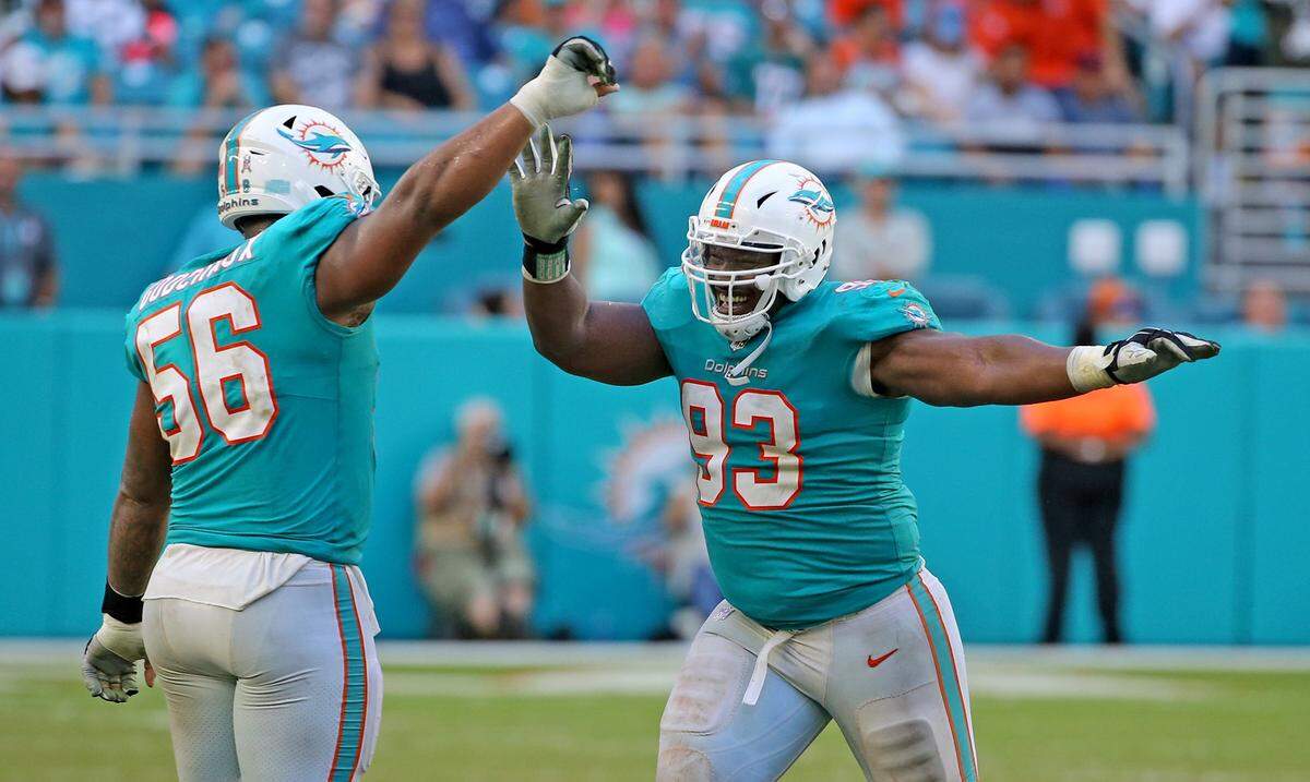 Dolphins defensive tackle Akeem Spence (93) celebrates with Davon Godchaux (56) after a Spence sack in the Dolphins’ 13-6 victory against the Jets, Nov. 4, 2018.