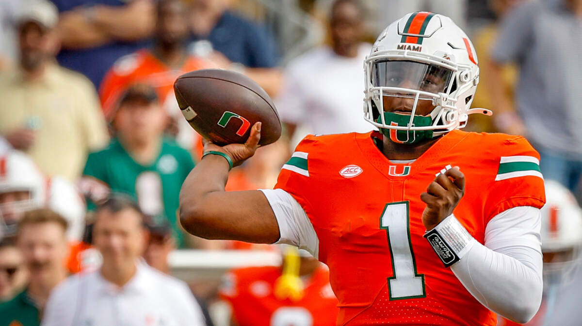Miami Hurricanes quarterback Cam Ward (1) passes under pressure by Georgia Tech Yellow Jackets defenders in the second half during an NCAA game at Bobby Dodd Stadium at Hyundai Field in Atlanta, Georgia on Saturday, November 9, 2024.