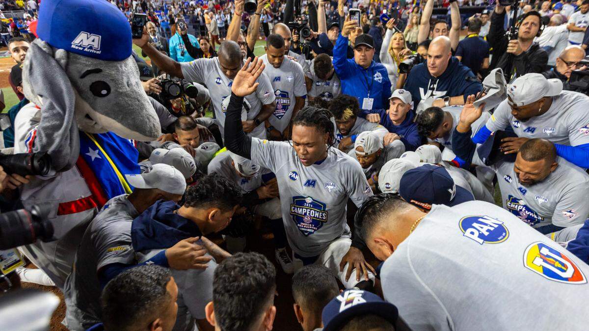 Venezuela pitcher Jojanse Torres (71) lead s the team in a prayer after defeating Dominican Republic 3-0 after the ninth inning of the Caribbean Series Championship baseball game at loanDepot park in Miami, Florida, on Friday, February 9, 2024.