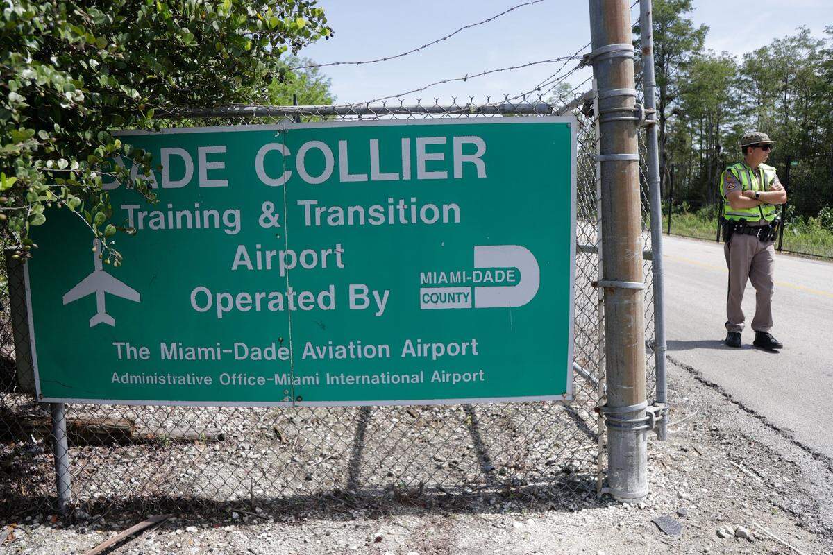 A Florida Highway Patrol trooper stands guard outside of the Dade Collier Training and Transition Airport, now repurposed as a detention facility and renamed Alligator Alcatraz on Saturday, July 12, 2025 in Ochopee.