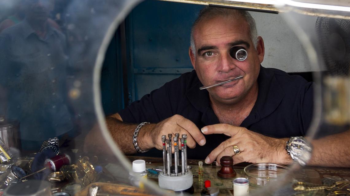 Carlos Ignacio Romero fixes watches at the Virgen del Camino market on the outskirts of Havana, Cuba, on Nov. 16, 2018. New regulations that put more restrictions on Cuba’s self-employed sector are going into effect Dec. 7, 2018.