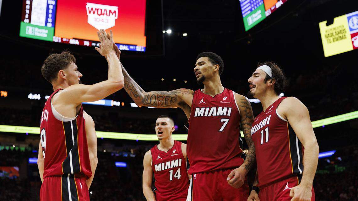 Miami Heat center Kel'el Ware (7) high-fives guard Pelle Larsson (9) with teammates Jaime Jaquez Jr. (11) and Tyler Herro (14) during the second half of a game against the Dallas Mavericks on Monday, Nov. 24, 2025, at the Kaseya Center in downtown Miami, Fla. The Miami Heat won 106-102.