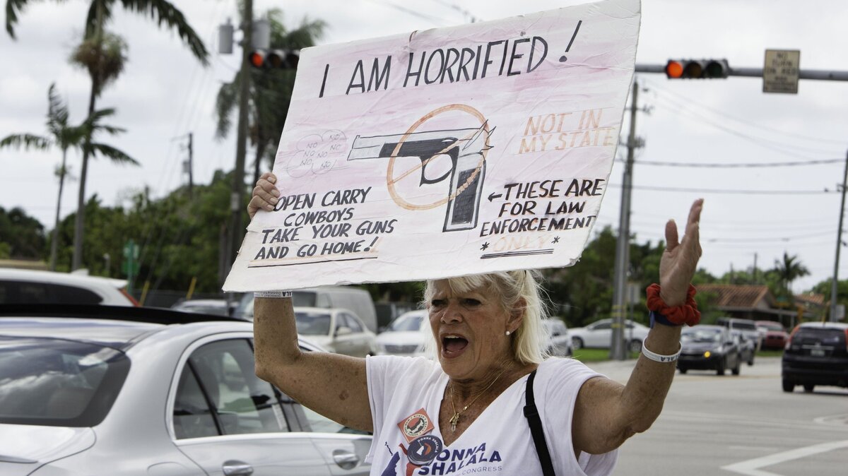 Miami, FL resident and mother of FIU students, Stephanie Rupp, holds an anti-gun sign at a Democrat rally against the gun shows held at the Miami-Dade Youth Fair in Miami, FL, on Saturday, September 1, 2018.