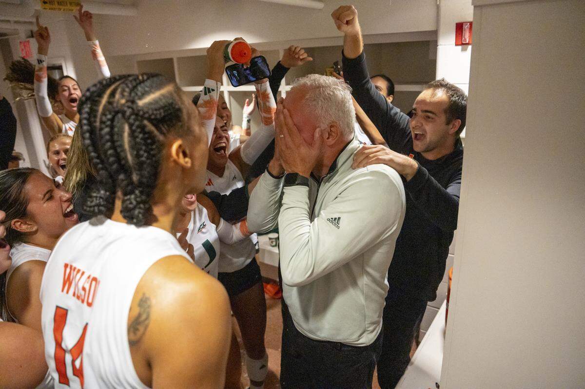 An emotional University of Miami volleyball coach Jose “Keno” Gandara celebrates with the Hurricanes players and coaches soon after they beat No. 1 ranked Texas on Saturday at Austin, Texas.