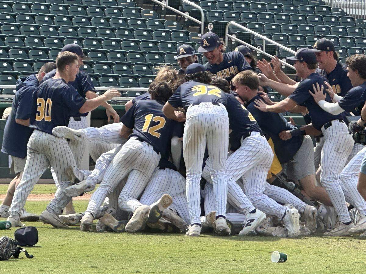 St. Thomas Aquinas players form a dogpile on the pitching mound seconds after a 5-1 win over Gainesville Buchholz in the Class 6A baseball state championship game at Hammond Stadium in Fort Myers, Fla.