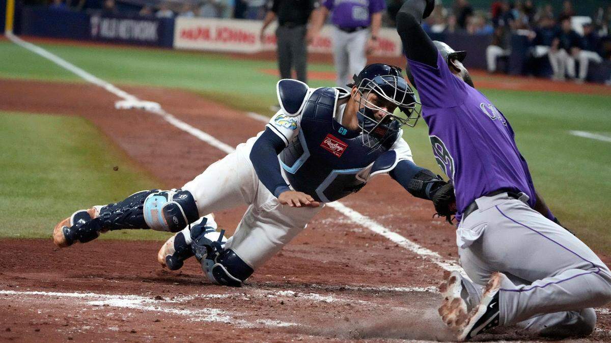 Aug 23, 2023; St. Petersburg, Florida, USA; Tampa Bay Rays catcher Christian Bethancourt (14) tags out Colorado Rockies left fielder Jurickson Profar (29) at home plate during the sixth inning at Tropicana Field. Mandatory Credit: Dave Nelson-USA TODAY Sports