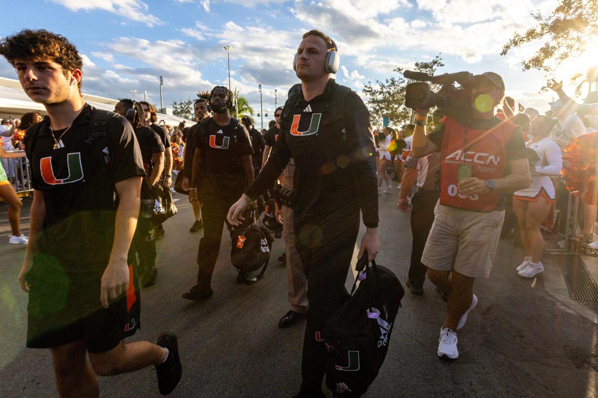 University of Miami quarterback Tyler Van Dyke (9) walks with his team during the Hurricane Walk before an ACC college football game against Clemson University at Hard Rock Stadium in Miami Gardens, Florida, on Saturday, October 21, 2023.