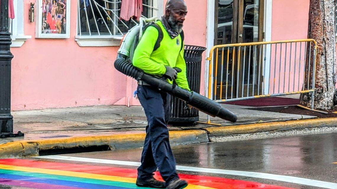A Key West city worker cleans the rainbow crosswalks on Duval Street to help prepare for Pride 2022.