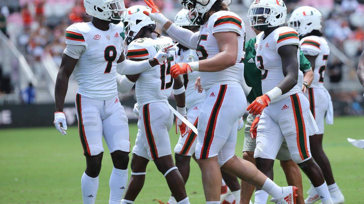 Miami Hurricanes offensive lineman Jacob Lichtenstein (55) is greeted by teammates after intercepting a pass during the spring game for the University of Miami at DRV PNK Stadium in Fort Lauderdale, Florida on Saturday, April 16, 2022.