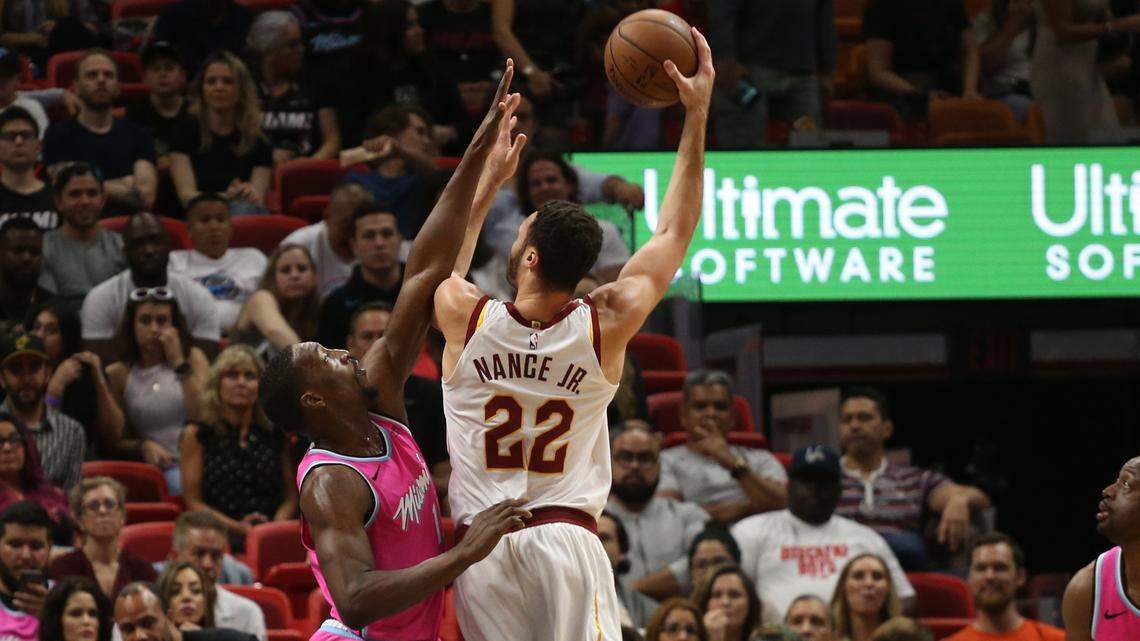 Heat center Bam Adebayo, left, puts on the defense on Cavaliers forward Larry Nance Jr., center, in the first half during the NBA game between the Miami Heat and the Cleveland Cavaliers at the American Airlines Arena on Friday, December 28, 2018 in Miami, Florida.