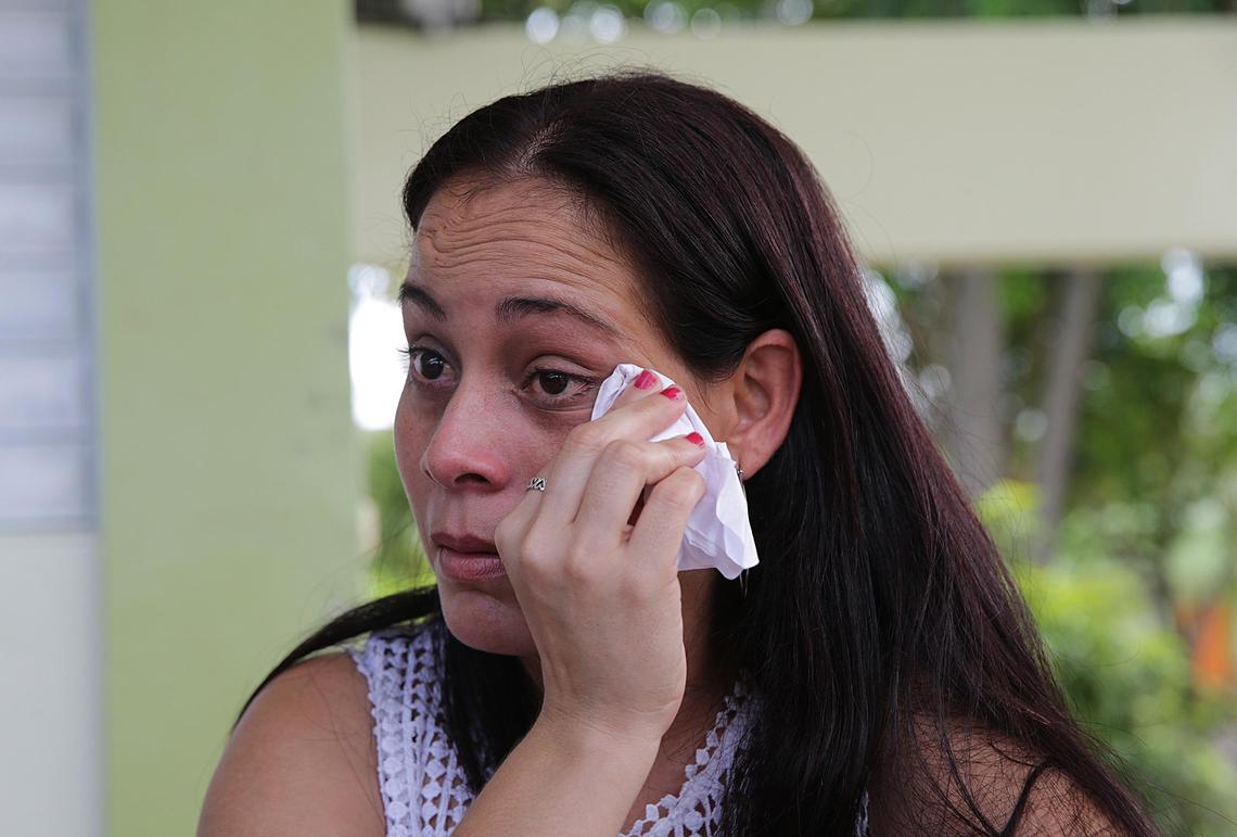 Yesenia Santiago cries as she talks about the effects that a school closure in Puerto Rico has had on her daughter Marylee, 10, who has Down syndrome. Any change is hard for Marylee and can delay development.