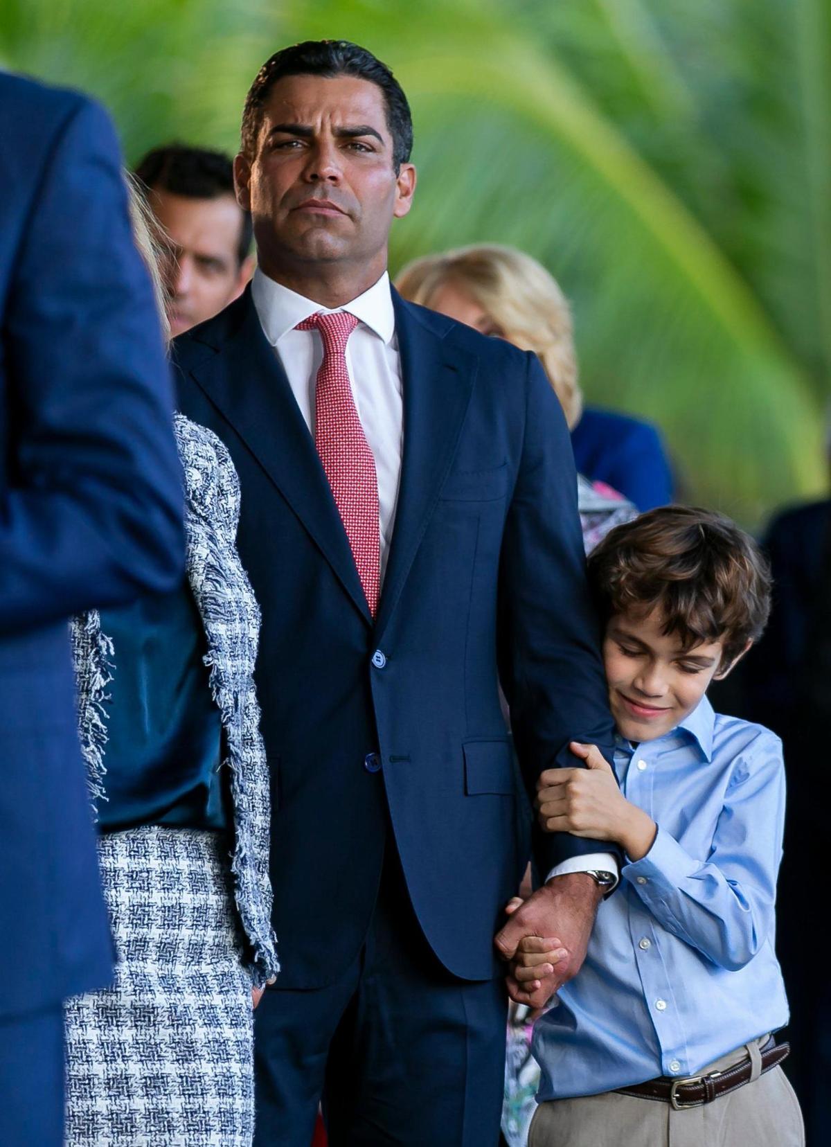 Miami Mayor Francis Suarez holds his son, Andrew Suarez, after being inaugurated as the 80th president of the U.S. Conference of Mayors at Maurice A. Ferré Park in downtown Miami on Monday, Jan. 3, 2022.