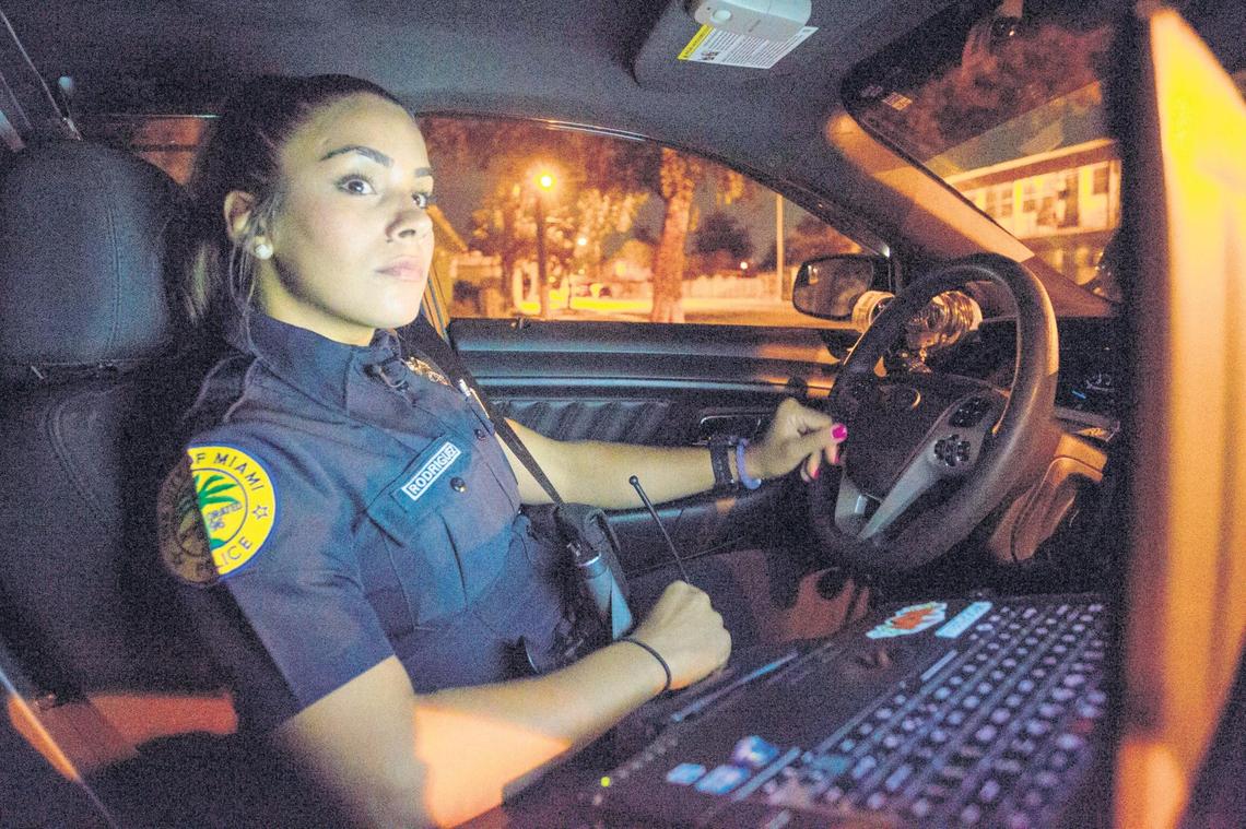 Miami police officer Natalie Rodriguez patrols on duty through Miami's Liberty City. She is part of an influx of extra officers intended to help make the streets safer at the public housing project.