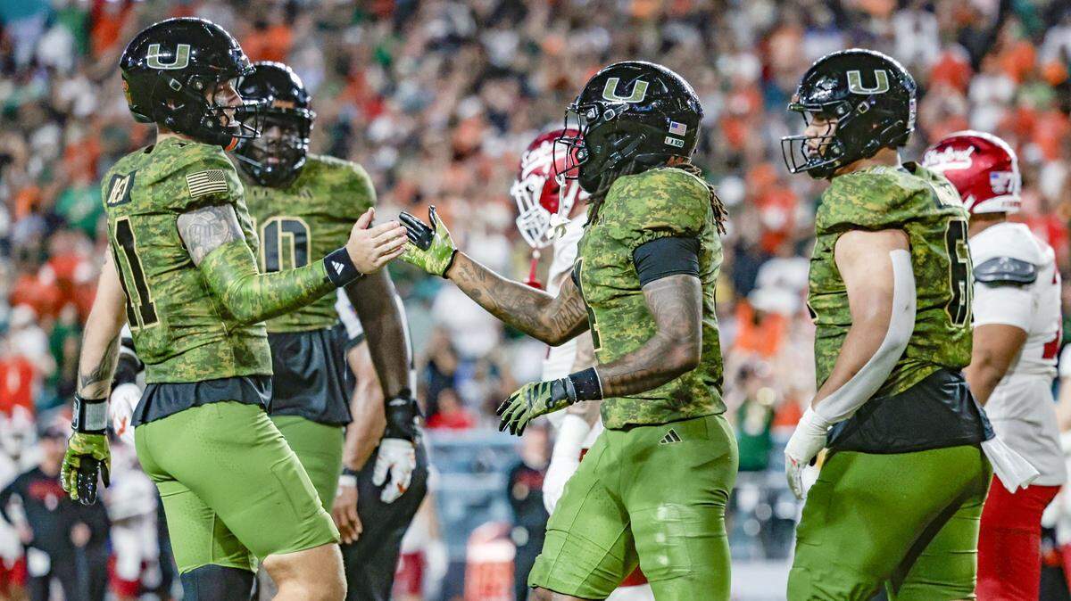 Miami Hurricanes quarterback Carson Beck (11) celebrates with unning back Mark Fletcher Jr. (4) after Fletcher scores in the second half during their NCAA football game against the Stanford Cardinal at Hard Rock Stadium in Miami Gardens, Florida, on Saturday, October 25, 2025.
