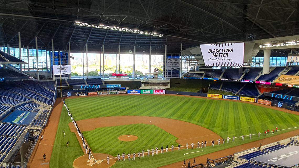 The Miami Marlins and Atlanta Braves stand on the baselines prior to the Marlins’ home opener on Friday, Aug. 14, 2020, at Marlins Park.