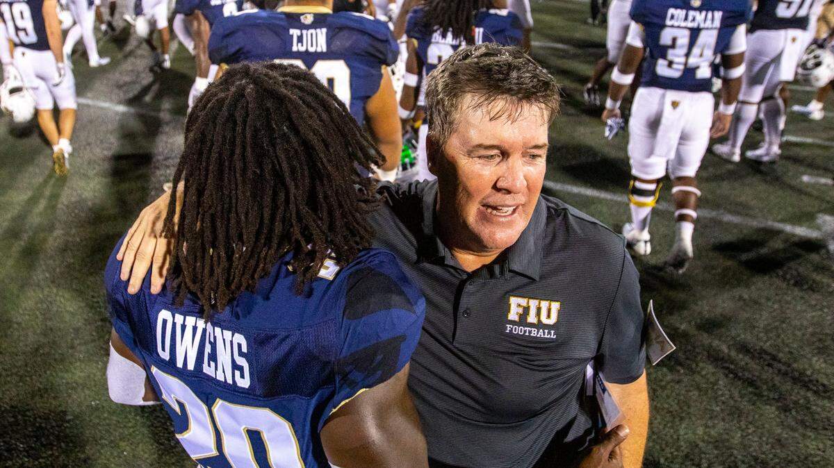 Florida International University Head Coach Mike MacIntyre reacts with running back Kejon Owens (20) after defeating Bryant University 38-37 in overtime of an NCAA Conference USA football game at Riccardo Silva Stadium in Miami, Florida, on Thursday, September 1, 2022.