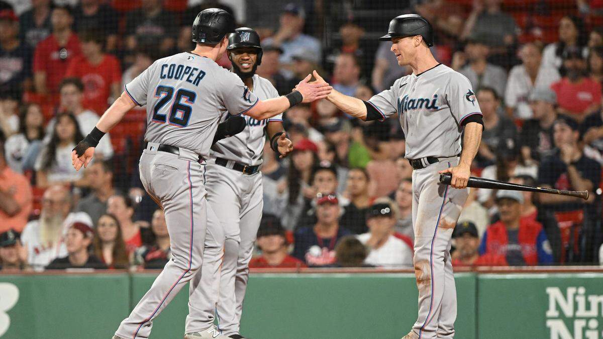 Jun 28, 2023; Boston, Massachusetts, USA; Miami Marlins first baseman Garrett Cooper (26) high-fives Miami Marlins shortstop Joey Wendle (18) after scoring a run against the Boston Red Sox during the sixth inning at Fenway Park. Mandatory Credit: Brian Fluharty-USA TODAY Sports