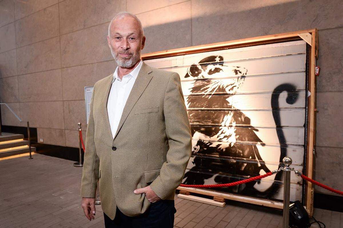Brian Greif poses in front of the famed “Haight Street Rat” artwork by Banksy in Toronto in June 2018. The piece will anchor the “Saving Banksy Miami” exhibition of street graffiti artists being held Dec. 6-9 at Superchief Gallery in Miami.