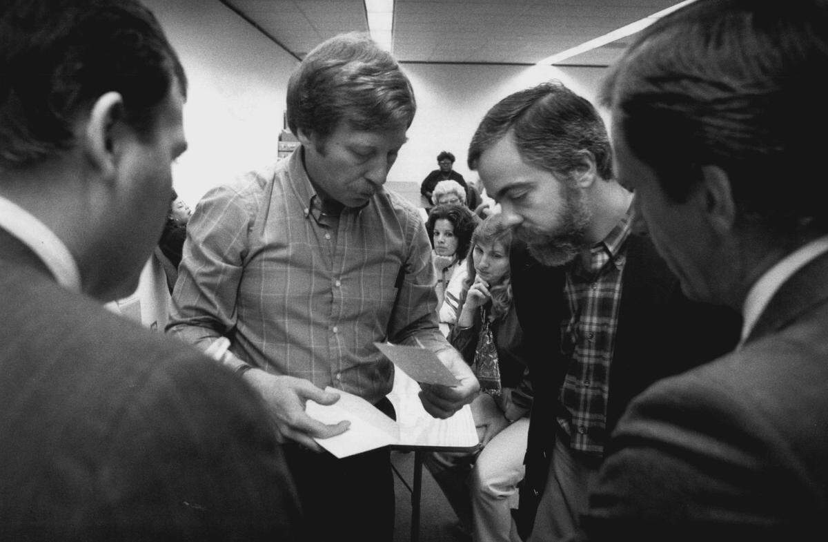 In 1988, David Leahy, elections supervisor inf Miami-Dade, holds a ballot (left background) while County Judge Steve Levine (right background) rules on it.