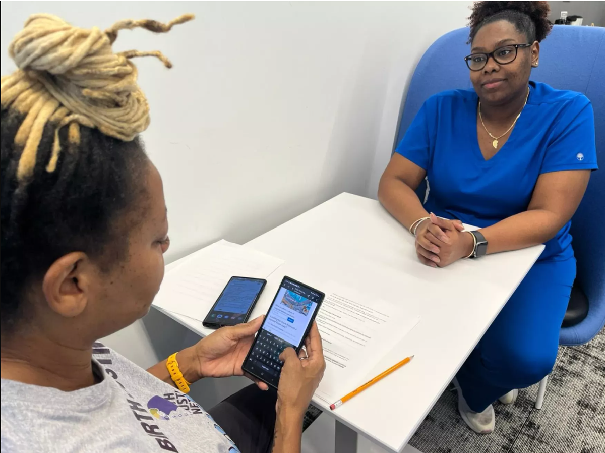 A South Florida doula conducting an extreme weather risk assessment with a pregnant client.