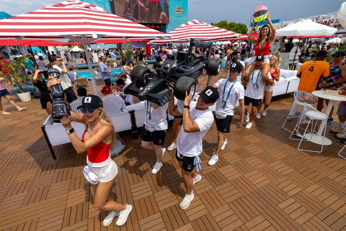 Bottle girls take a drink and F1 car to guests at The Beach Club inside Miami International Autodrome ahead of the Formula One Miami Grand Prix at the Miami International Autodrome on Sunday, May 4, 2025, in Miami Gardens, Fla.