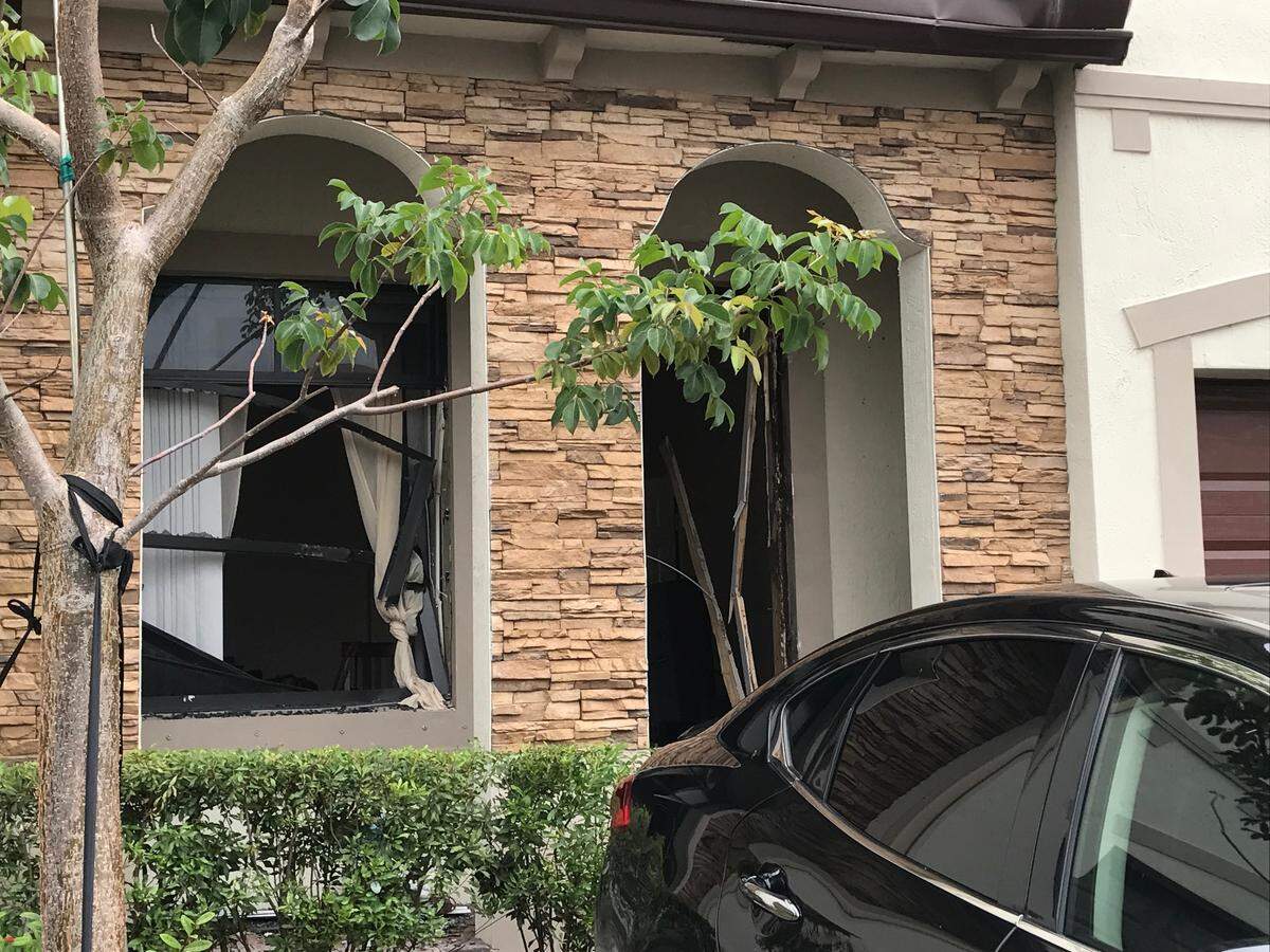 The windows and front door of a townhouse at 23825 SW 117th Court are smashed out following  hours-long standoff with Miami-Dade County Police that ended with a murder-suicide Monday morning, Sept. 10, 2018.
