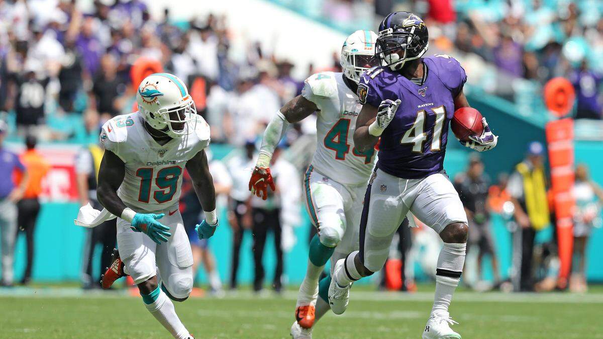 Anthony Levine Sr. (41) runs against then defense of Miami Dolphins wide receiver Jakeem Grant (19) and linebacker Deon Lacey (44) after a fake punt during second quarter of an NFL football game at Hard Rock Stadium on Sunday, September 8 2019, in Miami Gardens.