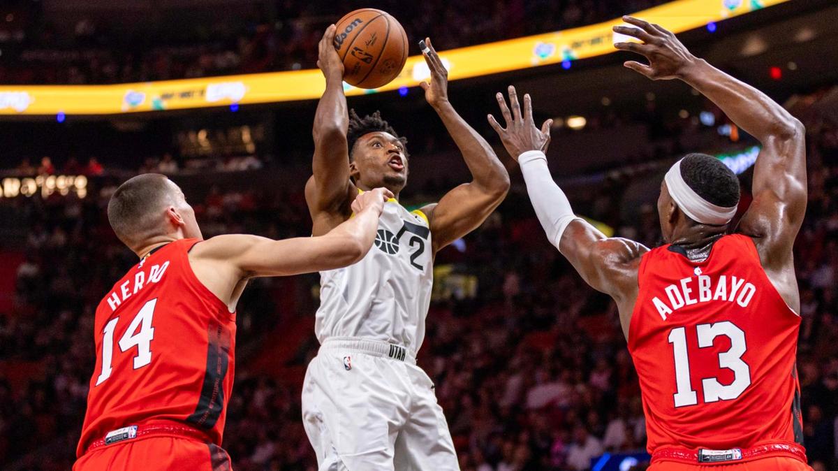 Utah Jazz guard Collin Sexton (2) shoots over Miami Heat guard Tyler Herro (14) and center Bam Adebayo (13) during the first half of an NBA game at the Kaseya Center on Saturday, January 4, 2025, in Miami, Fla.