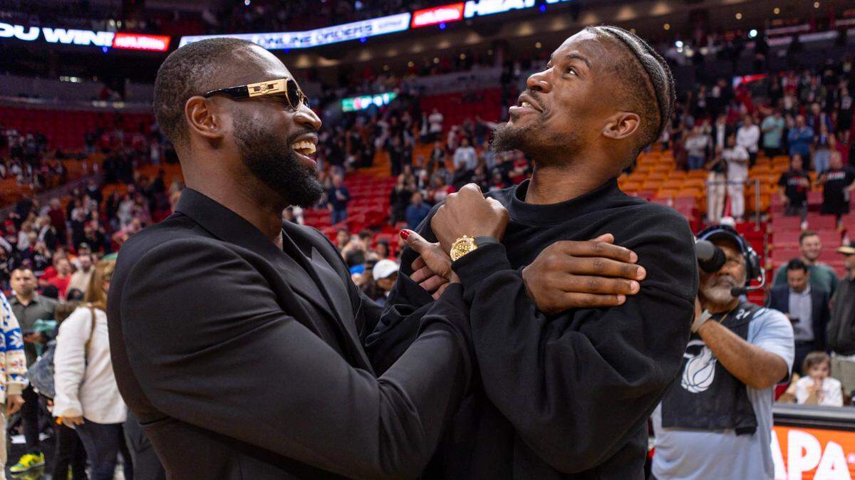 Miami Heat forward Jimmy Butler (22) reacts with former Heat player Dwyane Wade after the second half of an NBA game at Kaseya Center in Miami on January 14, 2024.