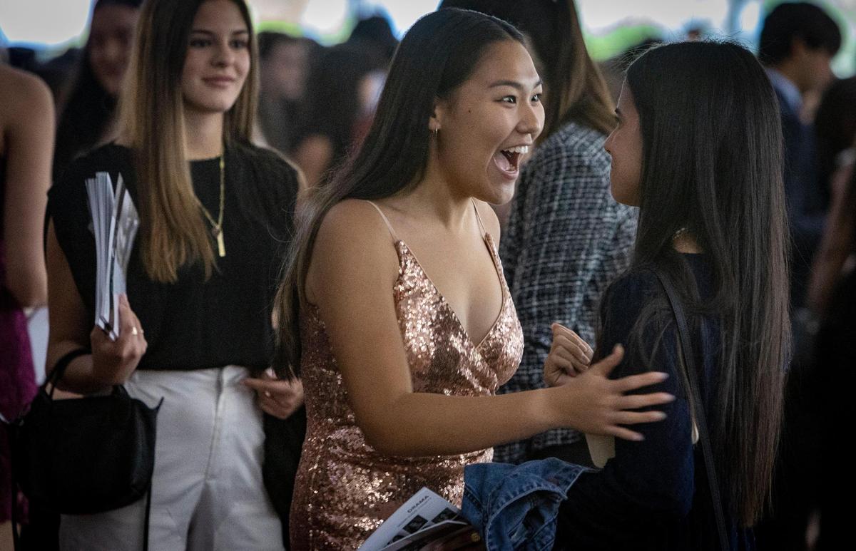 Diane Li, from the American Heritage School in Broward County, center, greets Alexandra Azan, right, from the Carrollton School of the Sacred Heart in Coconut Grove before the start of the Silver Knight Awards ceremony presented by the Miami Herald and el Nuevo Herald at the James L. Knight Center in Miami., Thursday, May 25, 2023. Both students were nominated in the Drama category.