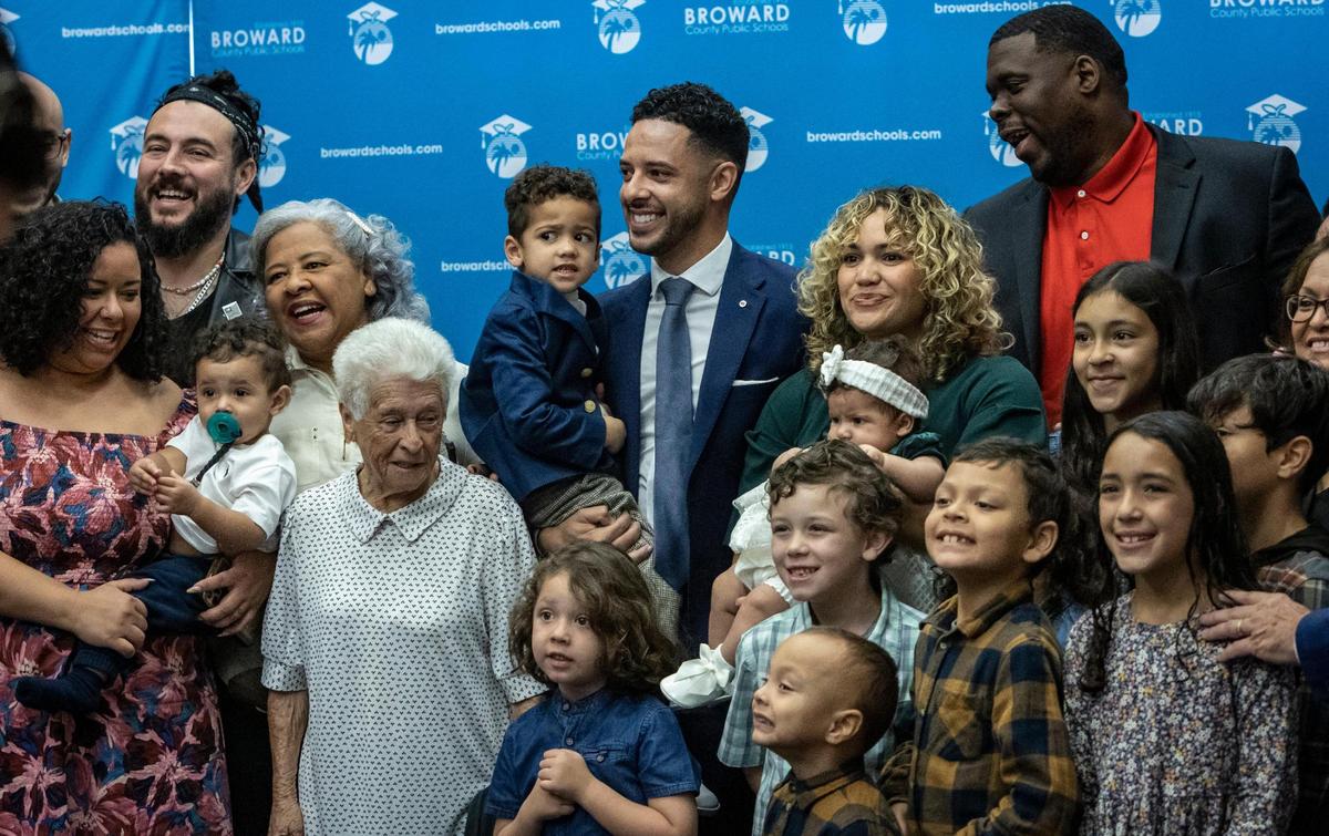 Newly appointed Broward County School Board Member Daniel P. Foganholi, center, holds his young son Daniel as family members joined him to pose for pictures after he was sworn in on Jan. 18, 2023, in Fort Lauderdale, Florida.