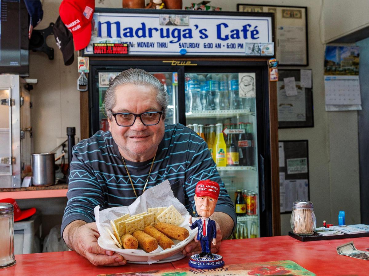 Owner Alberto Madruga displays a dish of “Trump Croquettes” from the menu of the Madruga’s Cafe, on Feb. 09, 2024.