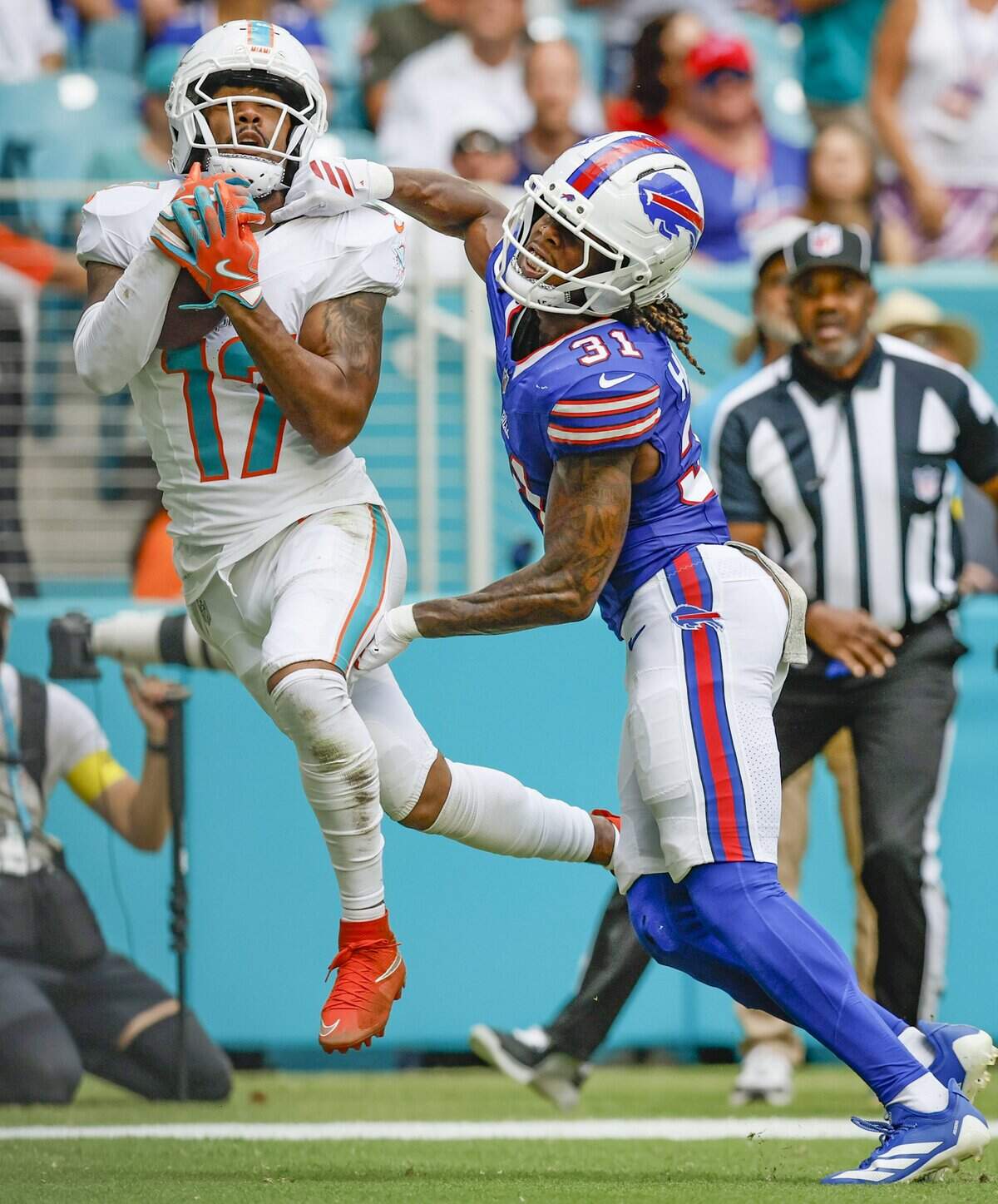 Miami Dolphins wide receiver Jaylen Waddle (17) catches a touchdown pass as Buffalo Bills cornerback Maxwell Hairston (31) defends in the first half of an NFL football game at Hard Rock Stadium in Miami Gardens, Florida on Sunday, November 9, 2025.