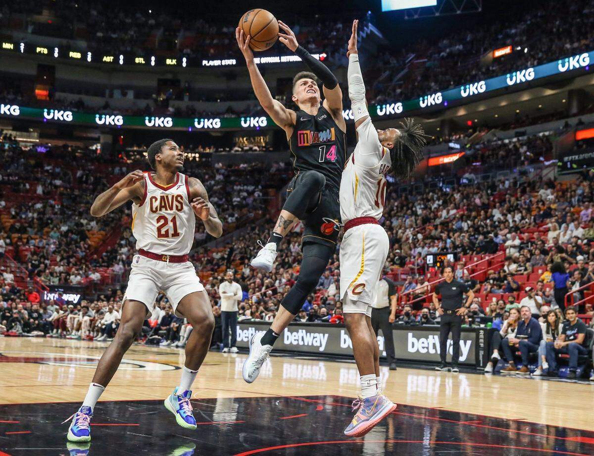 Miami Heat guard Tyler Herro (14) drives to the basket as Cleveland Cavaliers guard Darius Garland (10) defends in the first half at the FTX Arena in Miami on Friday, March 11, 2022.
