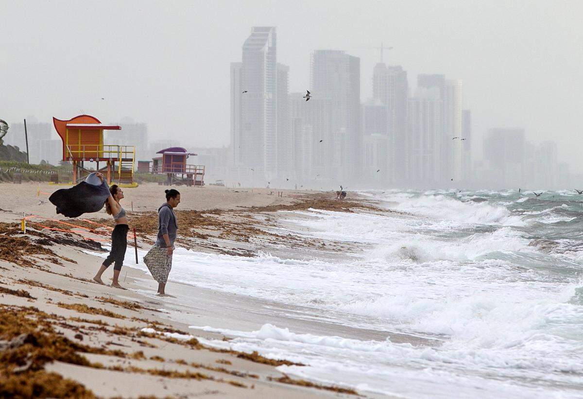 A couple walk on the beach by the 71st Street area in Miami Beach as Hurricane Isaias is forecast to arrive near the FL Atlantic coast tonight as a Category 1 hurricane, on Saturday August 01, 2020