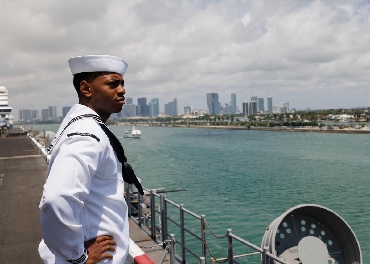 Erick Washington, religious program specialist, looks out at the bay and downtown Miami from the flight deck of the USS Bataan during the opening day of Fleet Week on Monday, May 6, 2024, at Norwegian Cruise Lines Terminal in PortMiami.